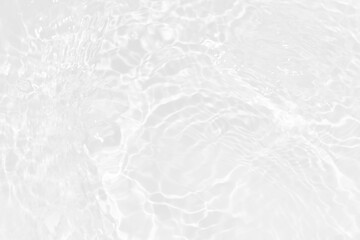 White water with ripples on the surface. Defocus blurred transparent white colored clear calm water surface texture with splashes and bubbles. Water waves with shining pattern texture background.
