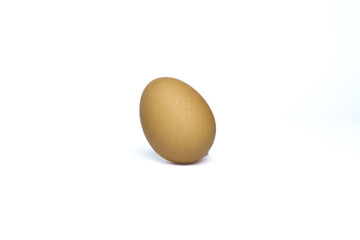 A single brown egg isolated on a white background