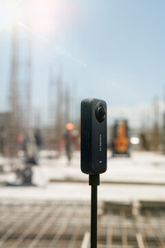Yerevan, Armenia - 01 06 2024: Insta 360 camera holding on a tripod in summer time in the construction site on the background