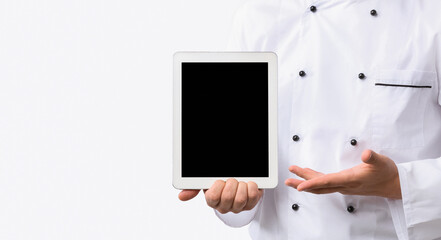 Unrecognizable Chef Guy Showing Empty Tablet Computer Screen Over White Studio Background. Cropped,...