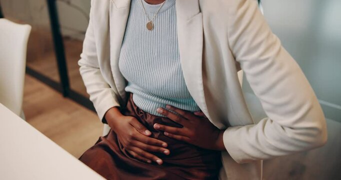 Hands, woman and massage for stomach ache in office with period cramps, menstruation crisis and digestion risk. Female person, abdomen pain and endometriosis emergency, gastro health and medical gut