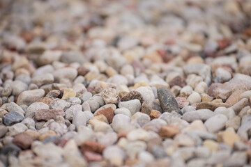 Bright stone pebbles close up on a river bed formation