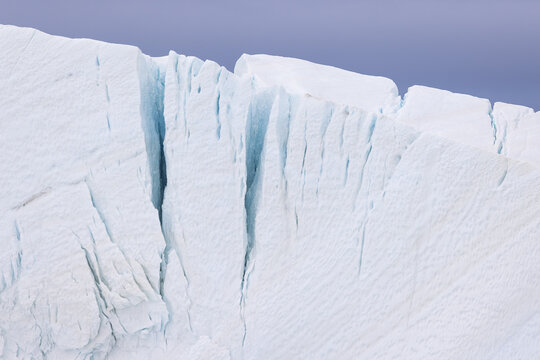 Detail of a white giant iceberg with cracks in Ilulissat Icefjord UNESCO World Heritage Site  in Greenland