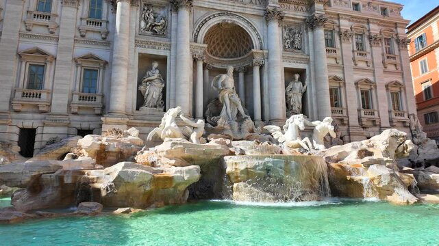 Full View of Trevi Fountain with Mythological Sculptures and Tourists in Rome.