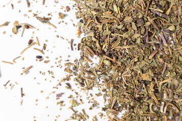 Dry basil spice seasoning macro texture on white background.