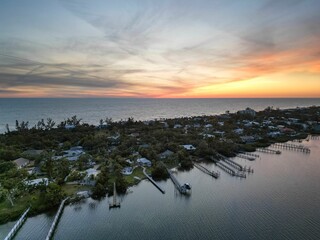 Naklejka premium Aerial view of a coastal town with docks and houses at sunset. Florida, USA