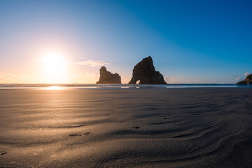 Golden sunset view of Archway Islands, Wharariki, New Zealand.