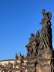 sculpture on charles bridge in prague in sunny winter light