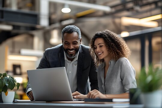Business multiracial professionals reviewing data on a laptop