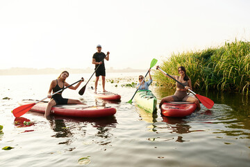 On the lake. Friends are together on sup boards