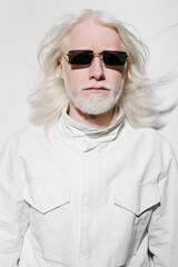 White haired man with sunglasses, stylish fashion concept against a plain white background, exuding confidence and modernity, ideal for lifestyle and fashion content