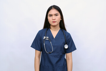 Healthcare workers, pandemic concept. Exhausted young asian female nurse, doctor looking tired after shift in hospital, looking sad with fatigue, standing white background in scrubs