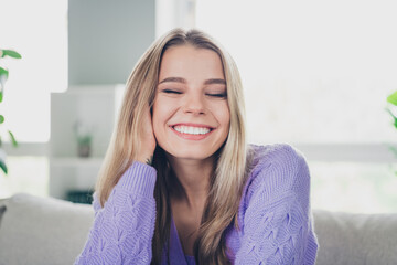 Photo of lovely cheerful girl sit couch charming cute enjoy comfort dressed violet garment spend...