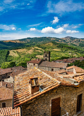Panorama of the town of Santa Fiora Tuscany Italy, in the foreground the roofs of the houses in the background the characteristic surrounding Tuscan countryside