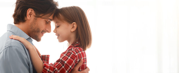 Connection, affectionate, bonding concept. Close up of young father and daughter cuddling over white background