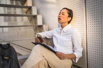 mature japanese woman sit outdoor hold flask and drink alcohol