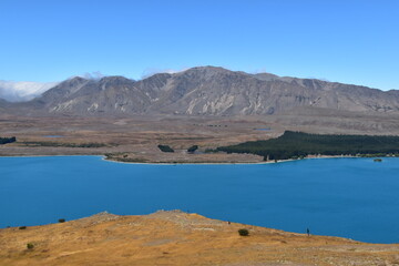 The stunning scenery and landscapes around the blue Lake Tekapo on the South Island of New Zealand