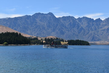 Walking along the Queenstown Gardens by the coastline of Lake Wakatipu on the South Island, New Zealand