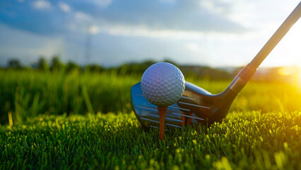 Golf clubs and balls on a green lawn in a beautiful golf course with morning sunshine.