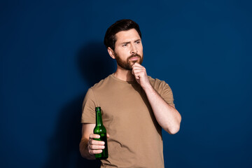 Photo portrait of mature age brunet bearded funny man in beige t shirt holding beer bottle minded...