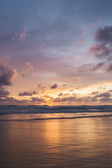 pink and orange sunset with clouds at karong beach in phuket