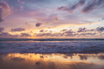 pink and orange sunset with clouds at karong beach in phuket