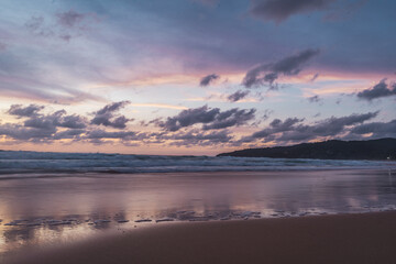 pink and orange sunset with clouds at karong beach in phuket