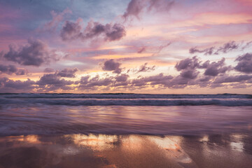 pink and orange sunset with clouds at karong beach in phuket