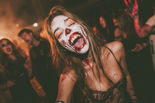 a photo of a happy woman at a halloween party dressed as a zombie