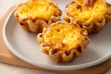 Delicious puff pastry Portuguese egg tart Pastel de nata in flower shape.