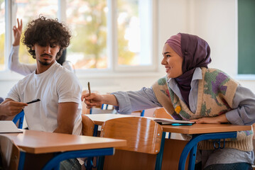 Fototapeta premium In the classroom group of diverse college students engages in discussion and knowledge exchange.