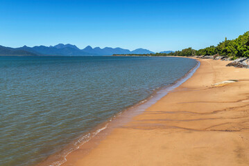 Pier and golden beach in Cardwell town in Queensland, Australia. Cardwell is coastal town and rural locality in Cassowary Coast Region.