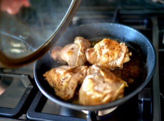 meat is fried in a frying pan in the kitchen