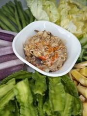 Nam Prik Pla Too is a popular Thai dish featuring a chili paste made from a mixture of fermented shrimp paste, chilies, garlic, lime juice, and palm sugar, served alongside crispy fried mackerel (Pla 