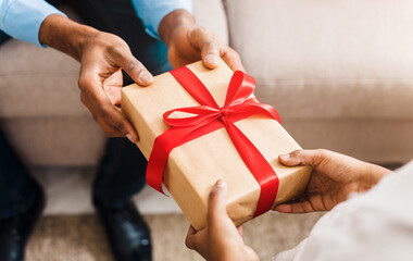 Father hands giving birthday gift to daughter, closeup