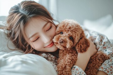 Japanese woman hugging and kissing her brown poodle puppy on bed