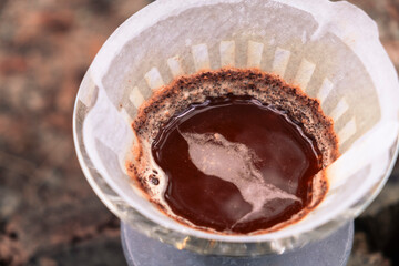 Coffee filter. Top view. Close-up. Foam on coffee. Coffee aroma. Trendy coffee in nature. Autumn atmosphere. Forest. Coffee on the road. Coffee in the forest