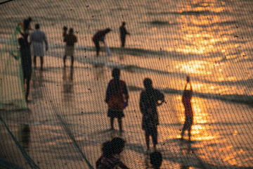 Silhouette of people at the beach during sunset