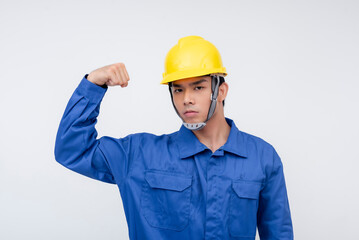 A Filipino worker flexes his bicep, showing determination and strength. Ideal for highlighting physical work, perseverance, and dedication in labor-intensive fields.