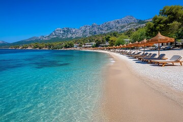 A quiet Thassos beach, dotted with sunbeds and umbrellas, where the calm waters of the Aegean lap gently at the shore