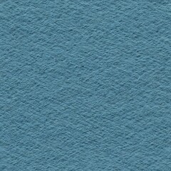 A small bird perched on the top of a blue wall