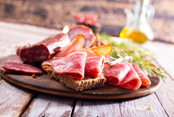 Different Italian ham and salami with herbs