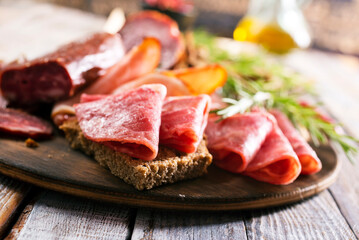 Different Italian ham and salami with herbs