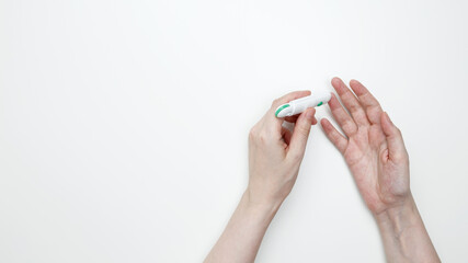 Woman using glucometer for testing level Blood sugar. Top view. Copy space