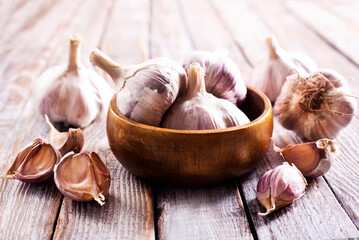 Garlic Cloves and Bulb in vintage wooden bowl.