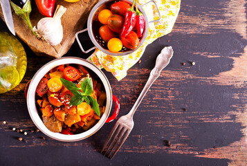 potato stew cooked with peppers, tomatoes, and onions, in bowl