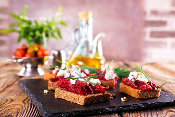 Baked beet on bread, with cheese and walnuts