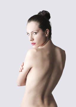 portrait of a young naked woman from behind. studio shoot