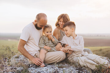 Happy Family Enjoying Quality Time Together Outdoors in a Scenic Landscape