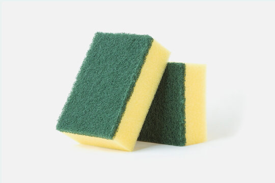 Yellow and green scrub sponge for dishwashing isolated on a white background 